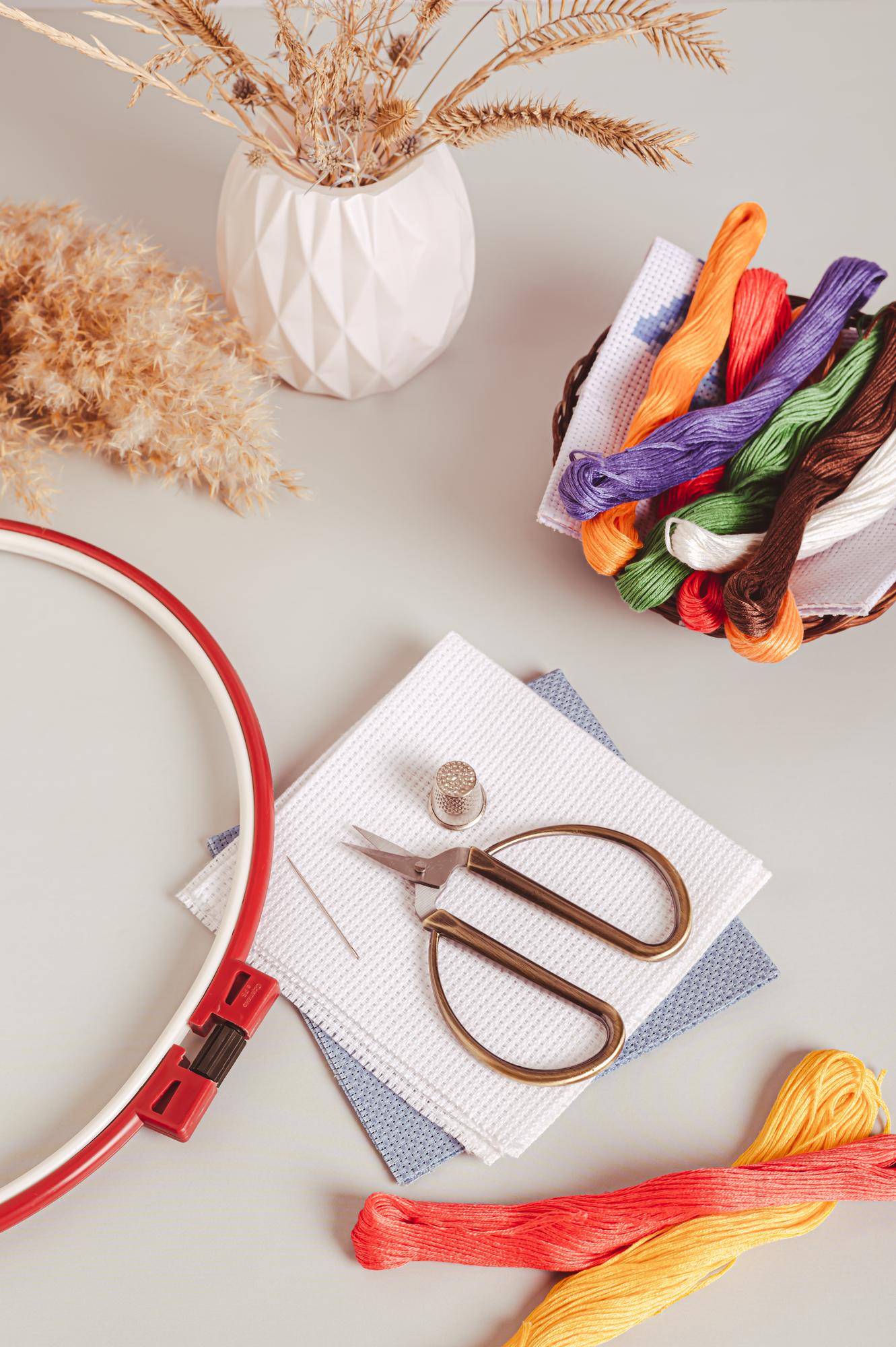 Workspace with embroidery tools and threads